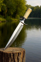 Knife with a wooden handle on a wooden stump by a body of water