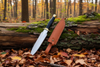 Knife with black handle and gold tip, accompanied by a brown leather sheath